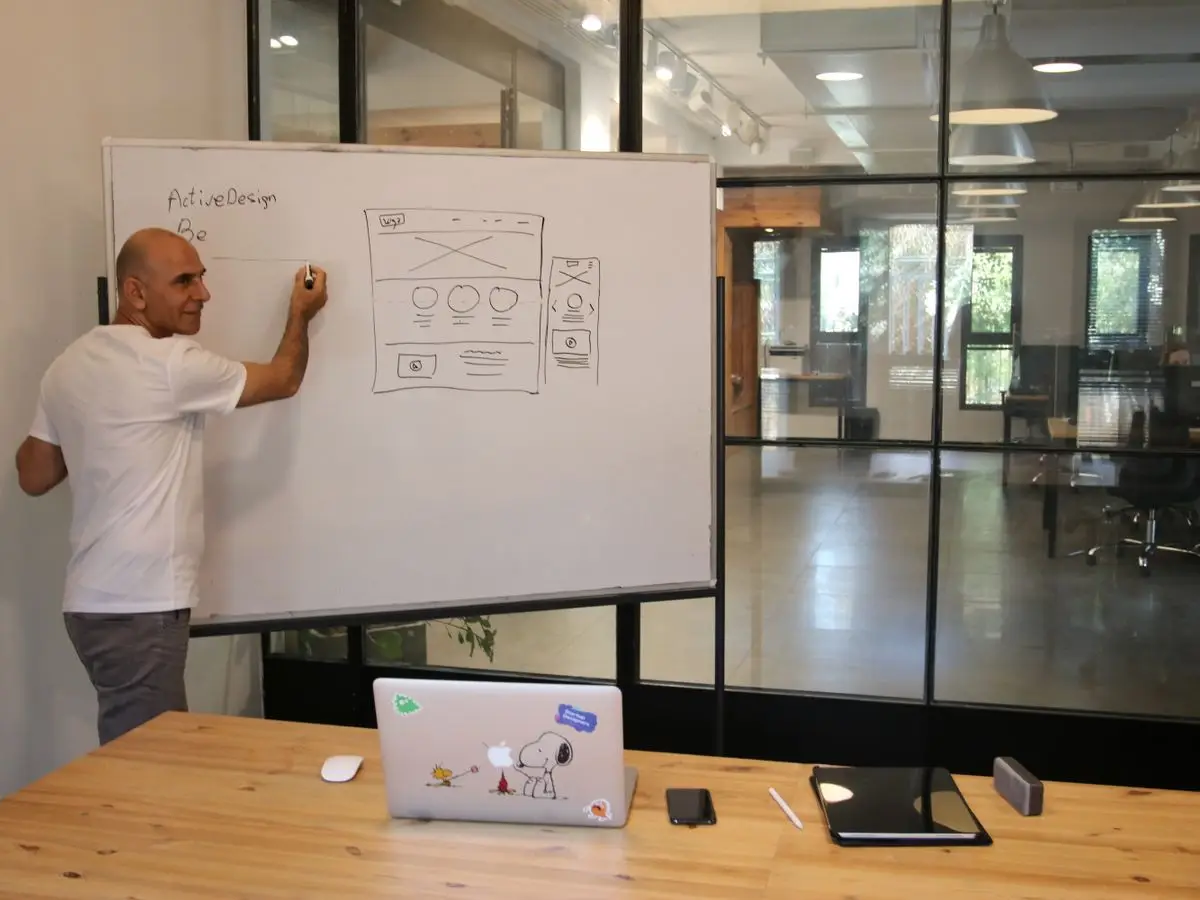 A person sketching a sitemap on a glass wall